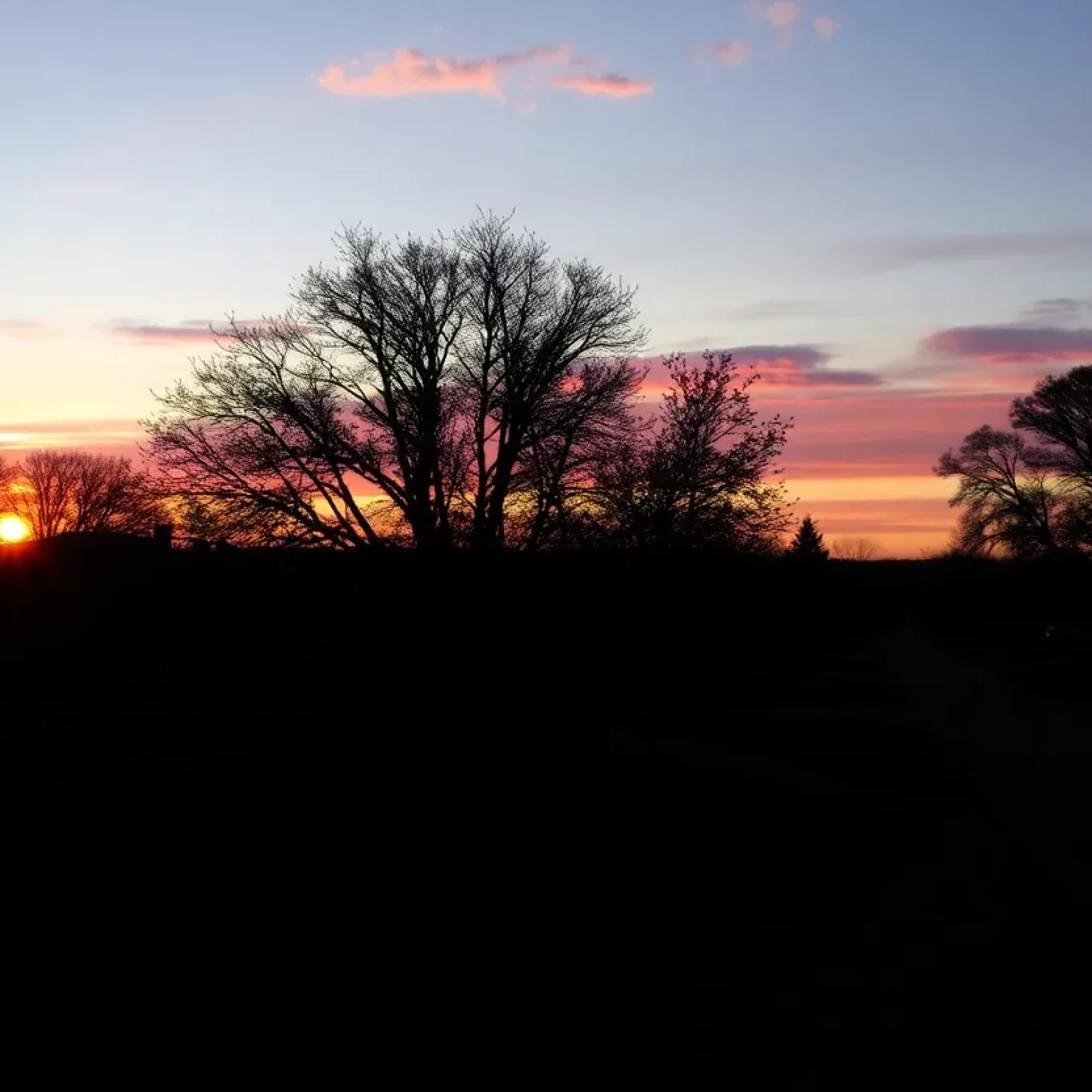 Sunset over a peaceful community representing loss and remembrance.